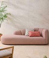 A stunning blush pink chaise sofa featuring elegant curves, deep seating, and contemporary luxury styling. Perfect for sophisticated modern interiors.
